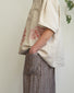 Pantalone alla caviglia con tasche asimmetriche e elastico in vita in lino marrone a righe