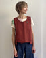 Gilet asimmetrico con tasca color mattone